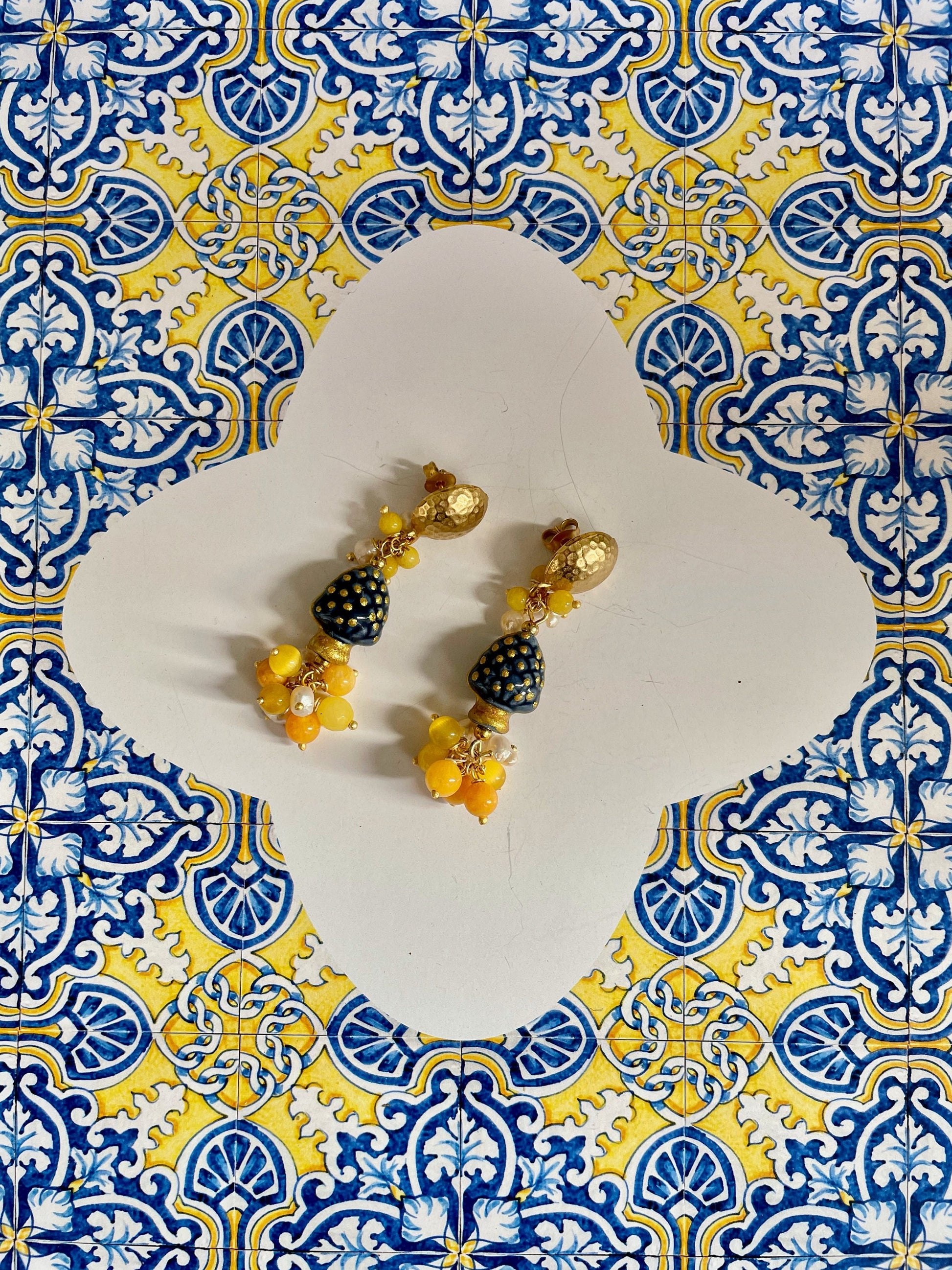 Orecchini pendenti con pigne di ceramica di Caltagirone, ottone, grappolo di pietre dure e perle di fiume §